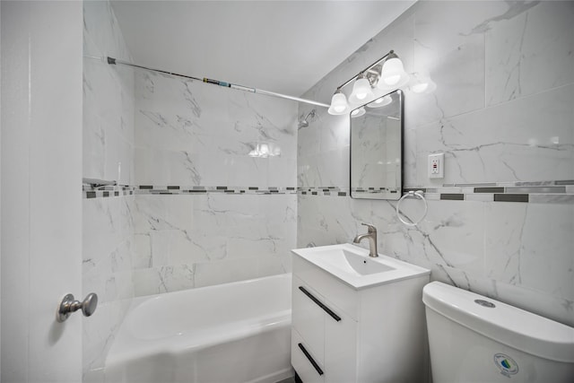 full bathroom with vanity, toilet, tile walls, and tiled shower / bath combo