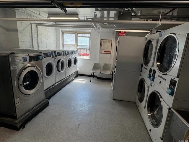 washroom with stacked washer / drying machine and washing machine and dryer