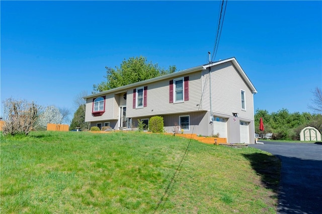 bi-level home with a front lawn and a garage