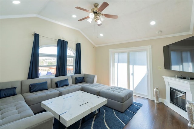 living room with dark hardwood / wood-style floors, ceiling fan, crown molding, and vaulted ceiling