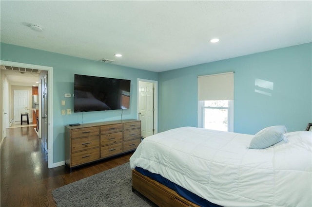 bedroom with dark hardwood / wood-style flooring