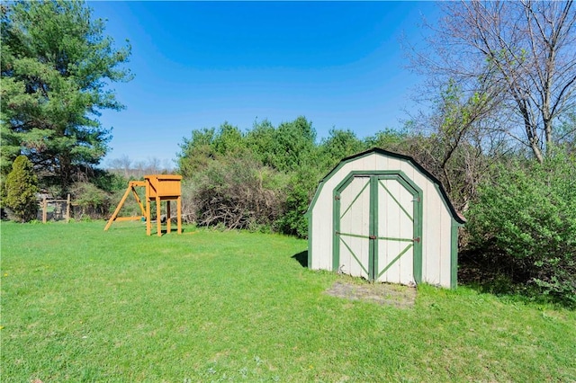 view of outdoor structure with a lawn and a playground