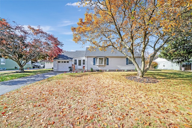 ranch-style house featuring a garage and a front yard