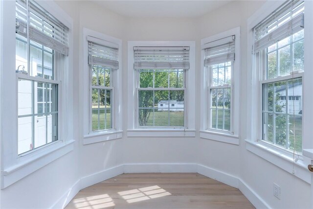 unfurnished sunroom featuring a healthy amount of sunlight