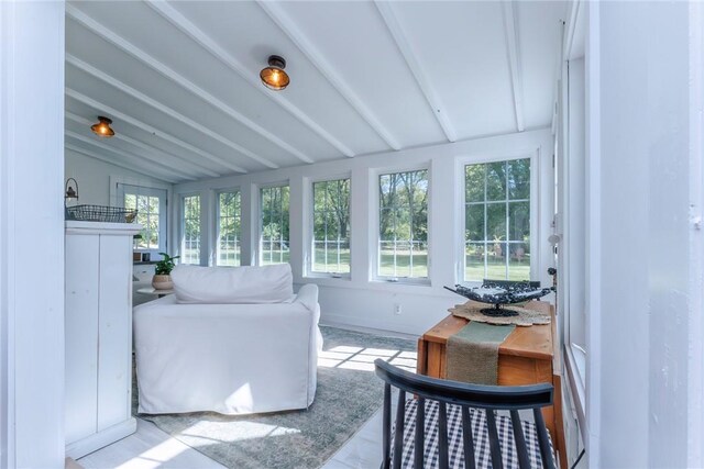 sunroom / solarium with vaulted ceiling with beams