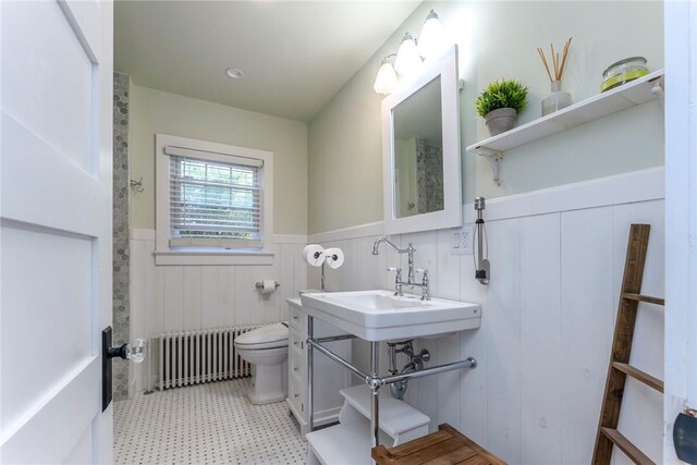 179 Grove St, Tillson, NY 12486 - bathroom with radiator heating unit, a wainscoted wall, toilet, tile patterned floors, and a sink