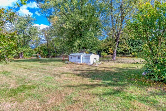 view of yard with a playground and a storage shed