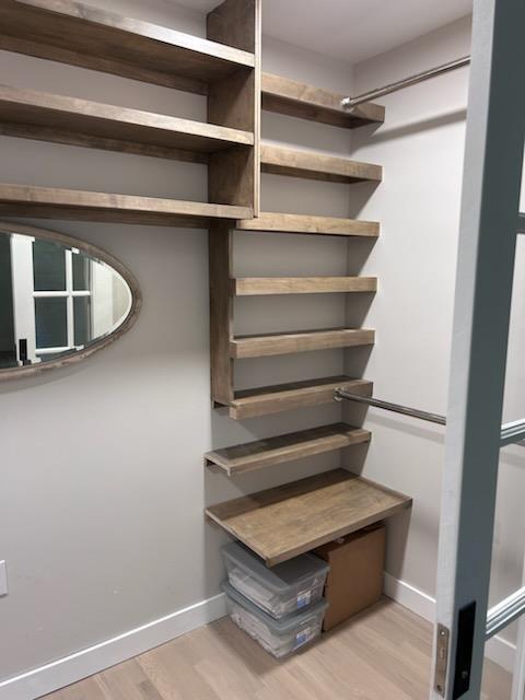 spacious closet featuring light hardwood / wood-style flooring