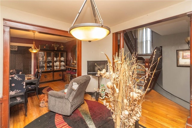 living room featuring hardwood / wood-style flooring and decorative columns