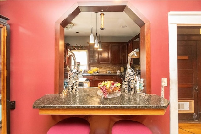 kitchen with decorative backsplash, light tile patterned flooring, and pendant lighting