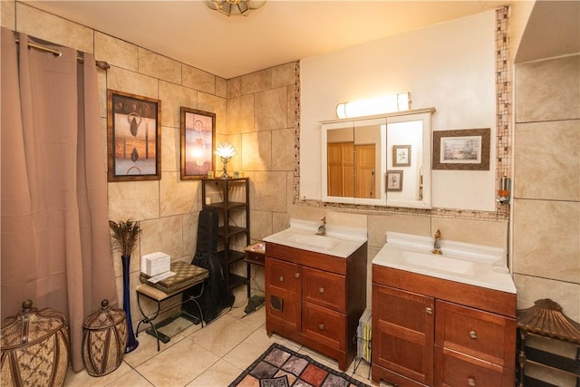 bathroom with tile patterned floors, vanity, and tile walls