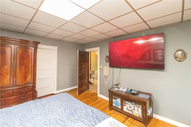 bedroom featuring hardwood / wood-style floors and a paneled ceiling