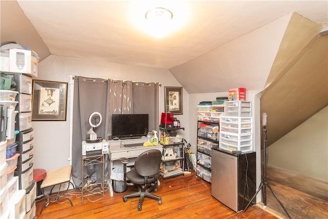 office space with hardwood / wood-style floors and vaulted ceiling