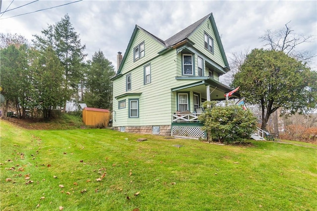 view of home's exterior featuring a yard and covered porch