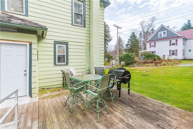 wooden terrace with a yard