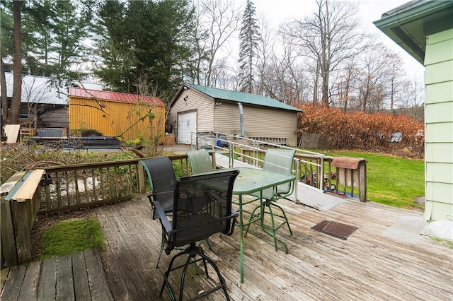 wooden deck featuring an outbuilding and a garage