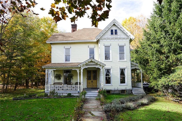 victorian home with a porch and a front lawn