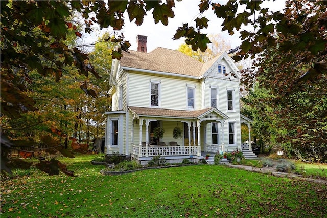 victorian-style house with a porch and a front yard