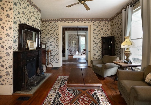 living room with dark hardwood / wood-style flooring and ceiling fan