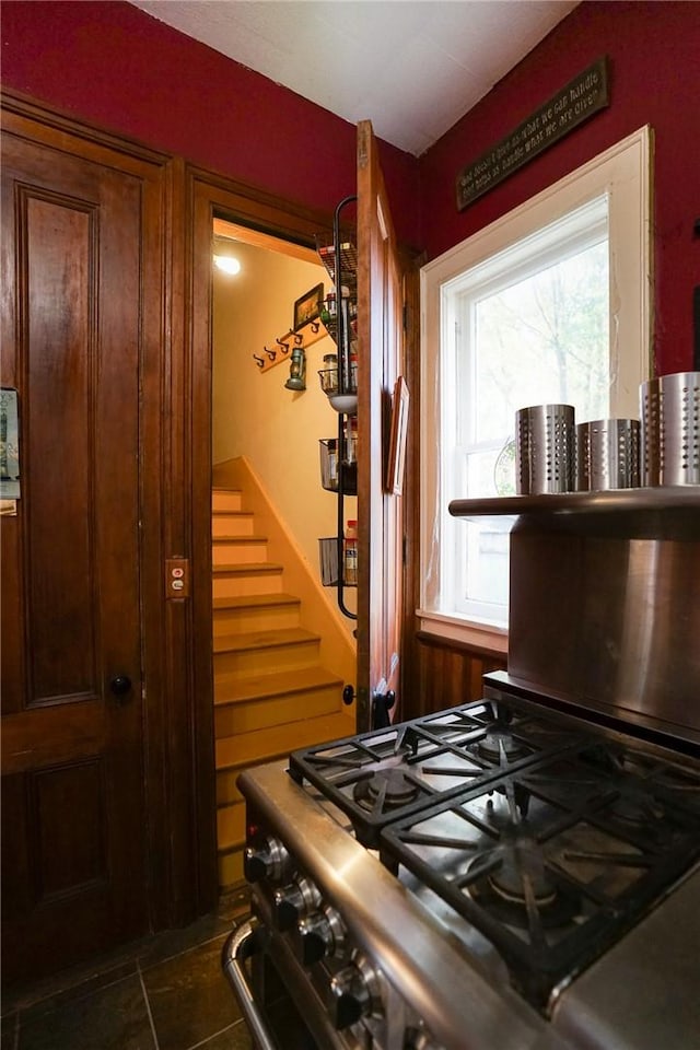 kitchen with high end stove and dark tile patterned flooring