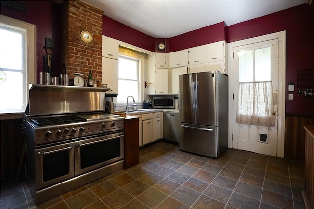 kitchen with white cabinetry, sink, and stainless steel appliances