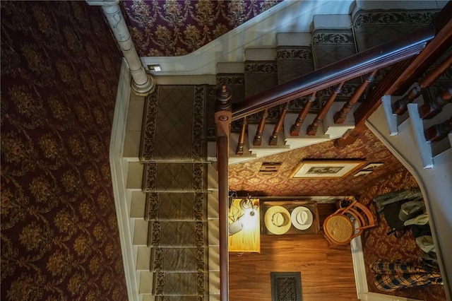 staircase with wood-type flooring