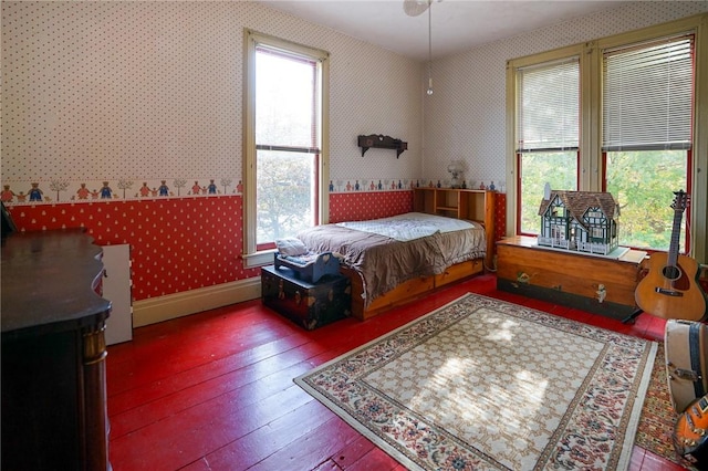 bedroom featuring hardwood / wood-style flooring and multiple windows