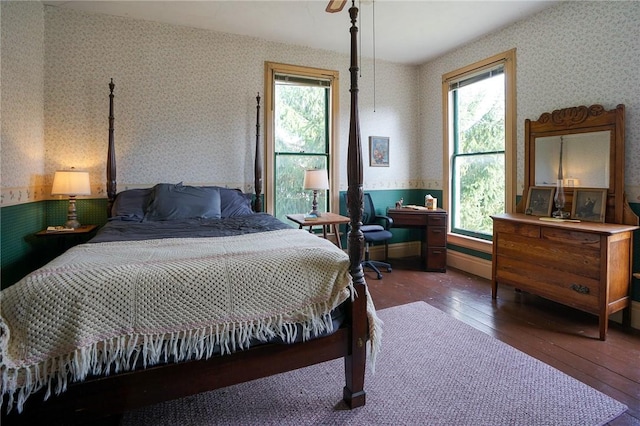 bedroom featuring dark hardwood / wood-style flooring and multiple windows