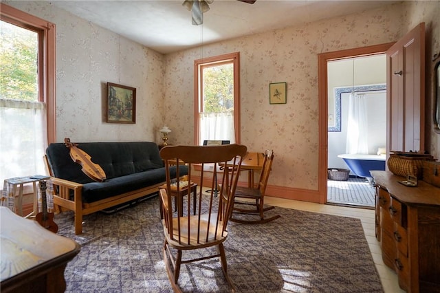 sitting room featuring ceiling fan and a healthy amount of sunlight