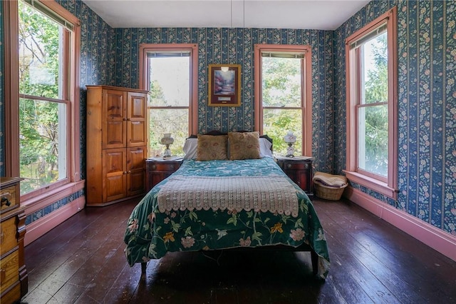 bedroom with dark hardwood / wood-style flooring