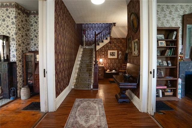 hallway with dark hardwood / wood-style flooring