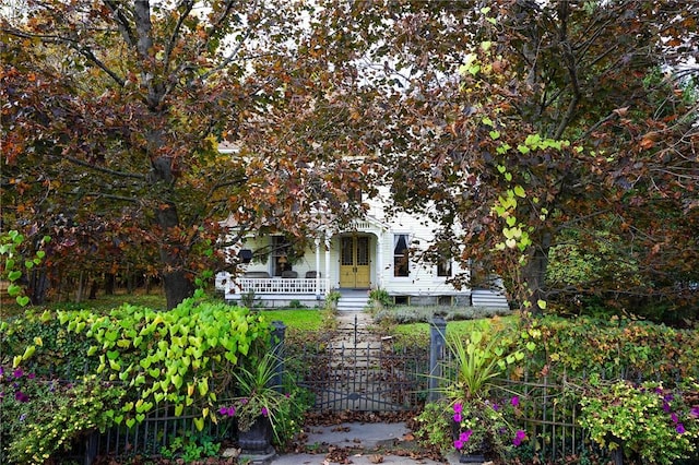 obstructed view of property with covered porch