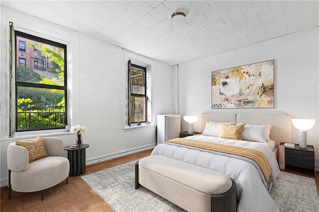 bedroom featuring multiple windows and wood-type flooring