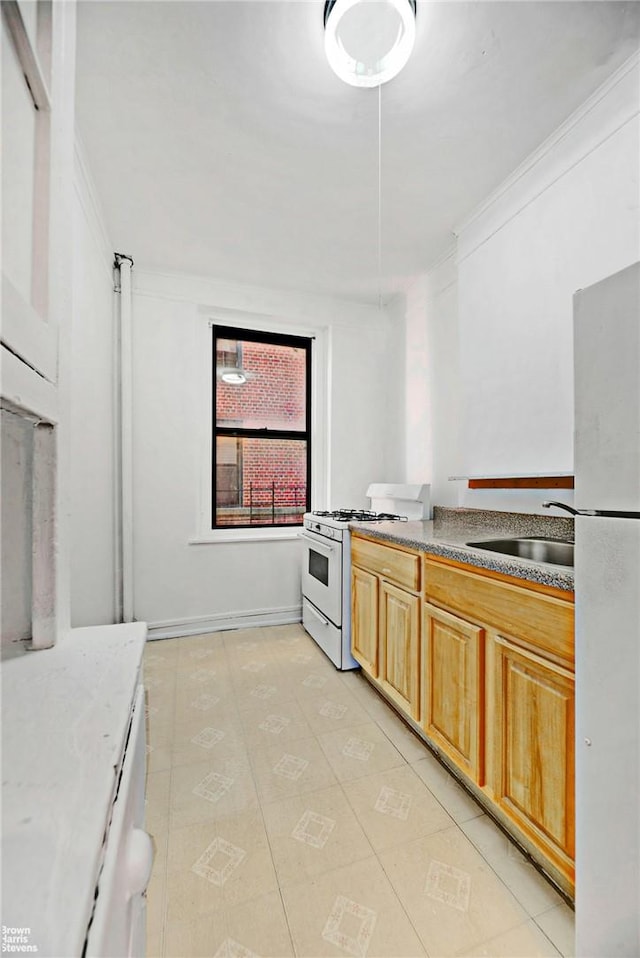 kitchen with crown molding, sink, light tile patterned flooring, and white appliances