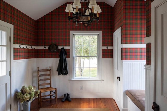 doorway to outside featuring hardwood / wood-style floors, an inviting chandelier, and vaulted ceiling