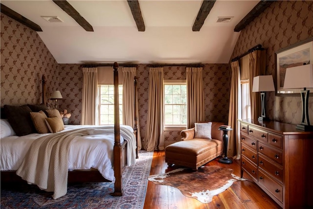 bedroom featuring ceiling fan, lofted ceiling with beams, and hardwood / wood-style flooring