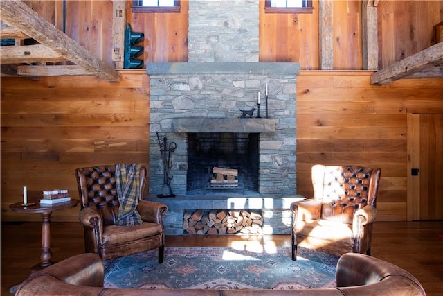 living room featuring a fireplace, wood walls, and hardwood / wood-style floors