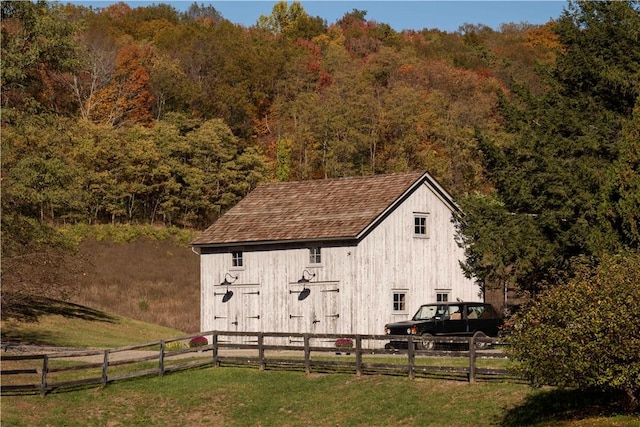 view of outbuilding with a yard