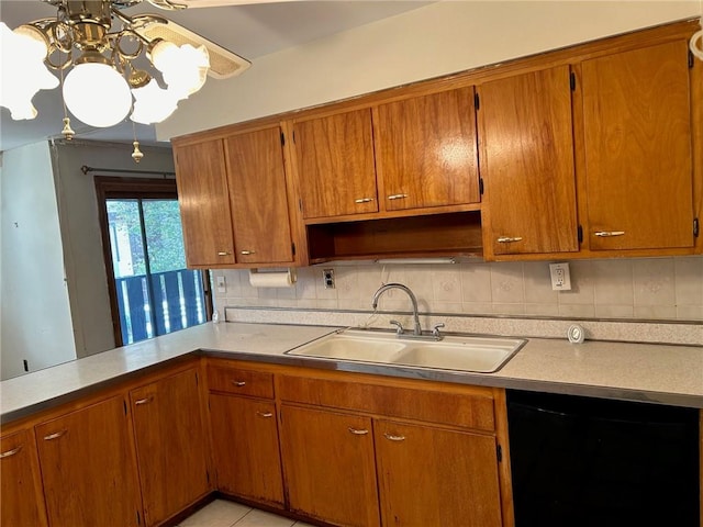 kitchen featuring decorative backsplash, dishwasher, a chandelier, and sink