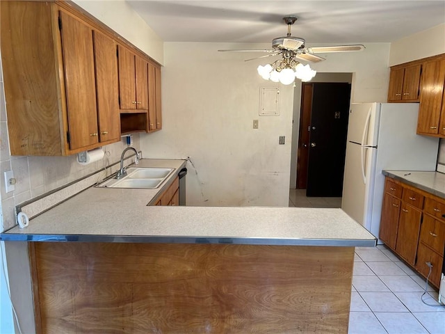 kitchen featuring ceiling fan, sink, stainless steel dishwasher, kitchen peninsula, and light tile patterned flooring