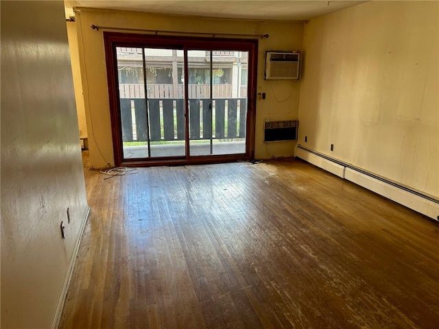 unfurnished room with hardwood / wood-style flooring, an AC wall unit, and a baseboard heating unit