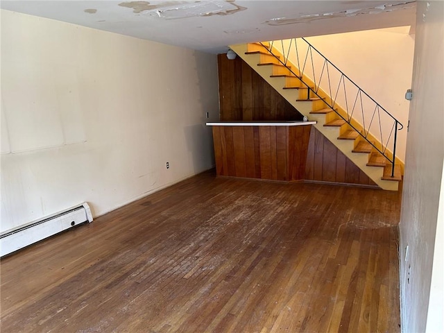 interior space featuring dark hardwood / wood-style flooring and a baseboard heating unit