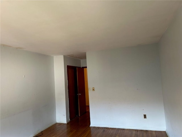 empty room with hardwood / wood-style flooring