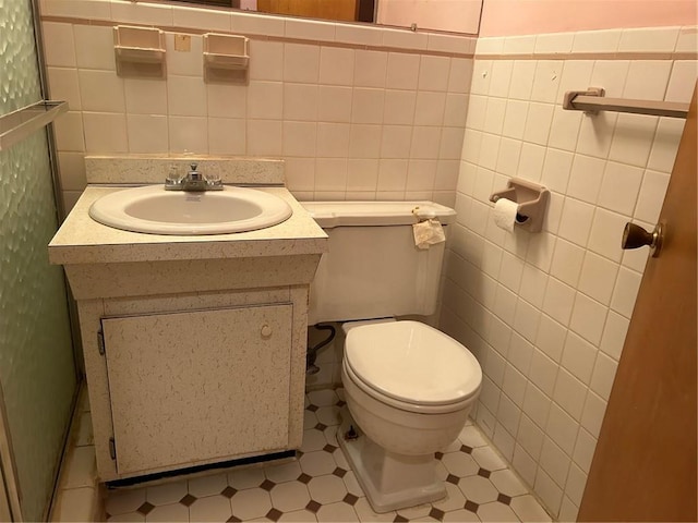 bathroom featuring vanity and tile walls