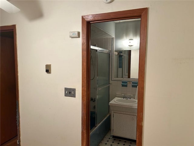 bathroom with vanity, tile patterned floors, and enclosed tub / shower combo