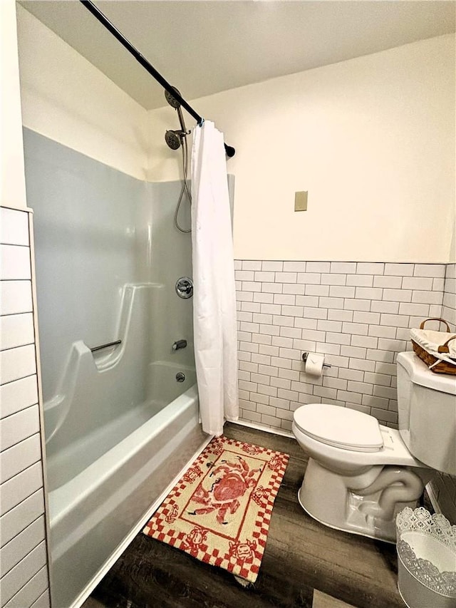 bathroom featuring hardwood / wood-style flooring, shower / bath combination with curtain, toilet, and tile walls