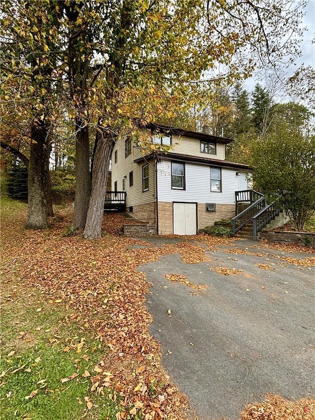 view of side of property featuring a wooden deck