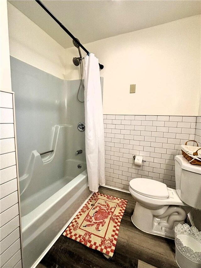 4 Worden Ln, White Sulphur Spring, NY 12787 - bathroom with toilet, wood finished floors, tile walls, wainscoting, and shower / bath combo