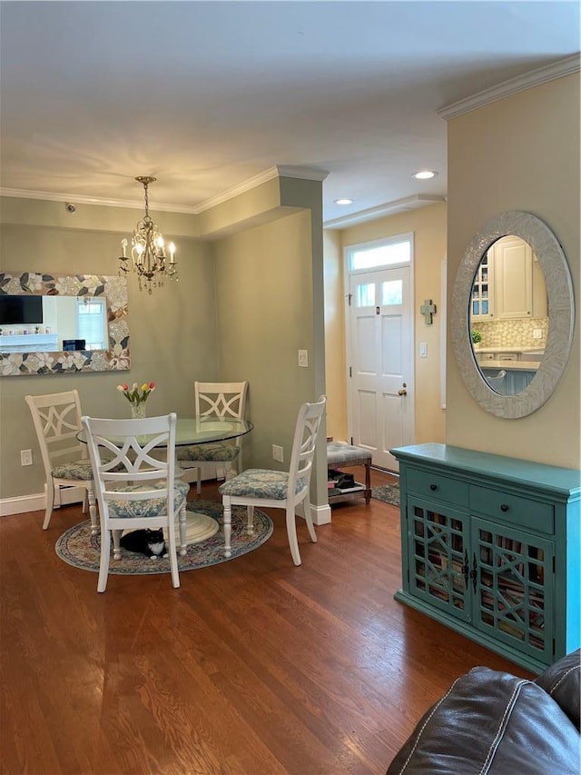 dining space featuring hardwood / wood-style floors, a notable chandelier, and ornamental molding