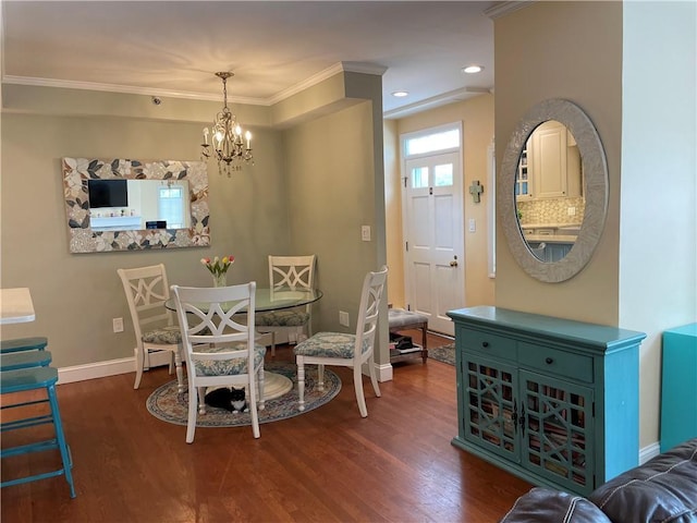 dining area with crown molding, dark hardwood / wood-style flooring, and an inviting chandelier